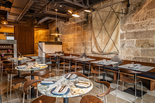 Tayim sandstone dining room with tables set for service
