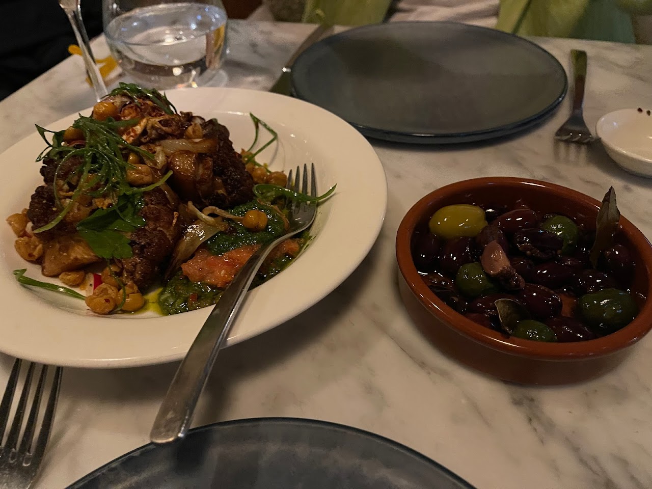 Middle Eastern share plates on a marble table at Tayim