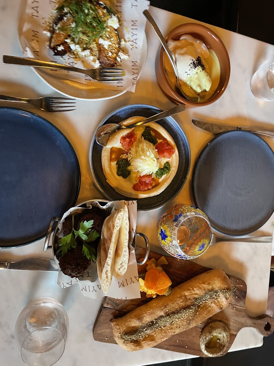 Table spread of dips and share plates at Tayim