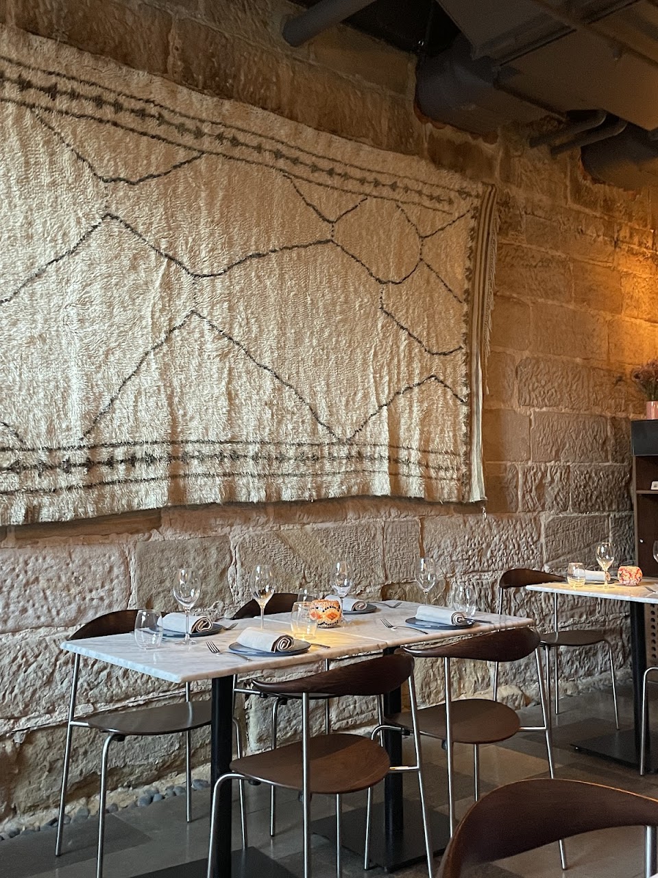 Stone wall dining alcove at Tayim